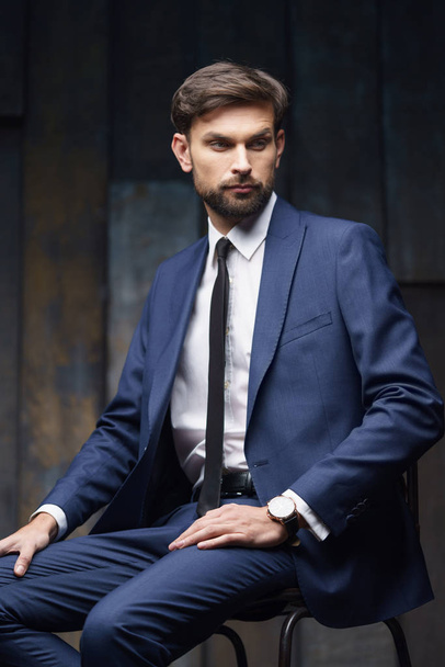 indoor photo of young handsome stylish businessman wearing suit - Fotó, kép