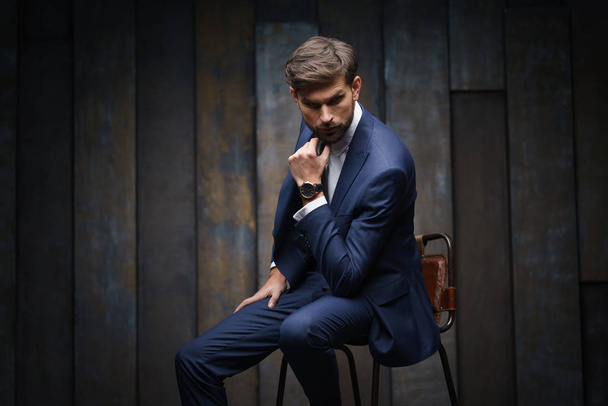 indoor photo of young handsome stylish businessman wearing suit - Fotó, kép