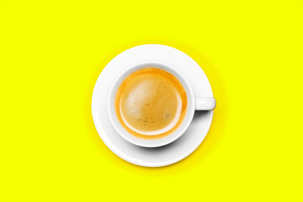 Black coffee in a cup on a yellow background - Φωτογραφία, εικόνα