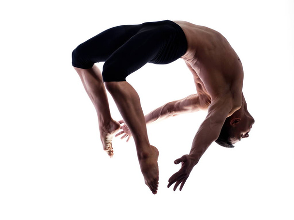 Man portrait gymnastic jumping bend - Foto, imagen