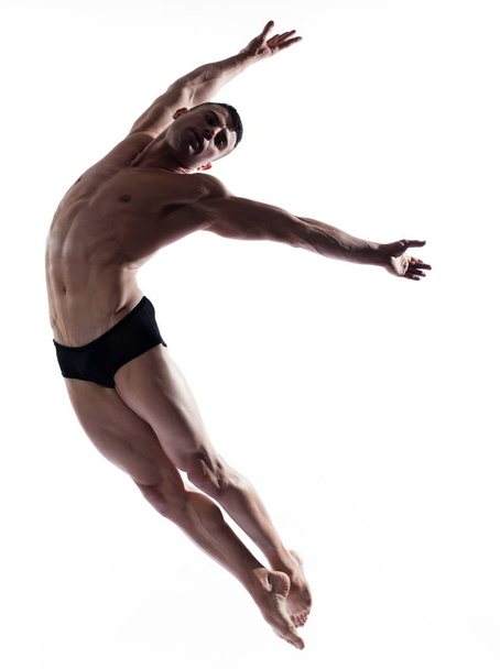 Man portrait gymnastic  jumping posture - Φωτογραφία, εικόνα