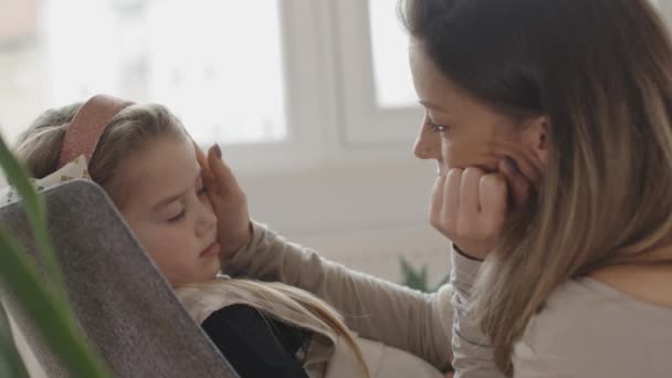 young mother pampering her sick daughter.  - Materiał filmowy, wideo