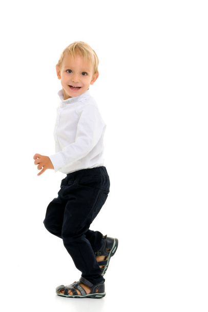 Little boy fun runs in the studio on a white background. - Fotó, kép