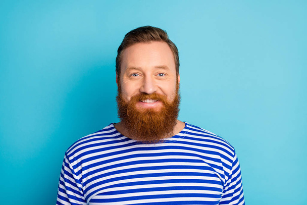 Portrait of charming content satisfied man look enjoy weekends wear striped vest isolated over blue color bakground - Valokuva, kuva
