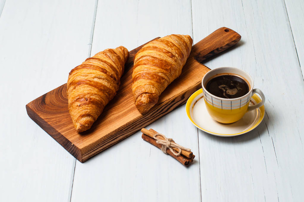 Croissants and coffee on light background. Concept delicious breakfast or lunch - Foto, Imagen