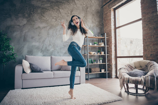 Full length body size view of her she nice attractive positive slim fit cheerful wavy-haired girl dancing listening music having fun showing v-sign modern loft industrial style interior living-room - Foto, Imagem