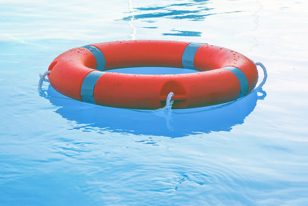 lifebuoy pool ring float. Life ring in swimming pool. - Photo, Image