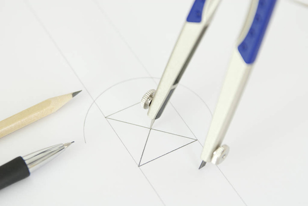 close up of a pencil and a pen on a white paper - Fotó, kép
