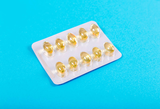 Pack of pills - fish oil - on a blue background - Foto, afbeelding
