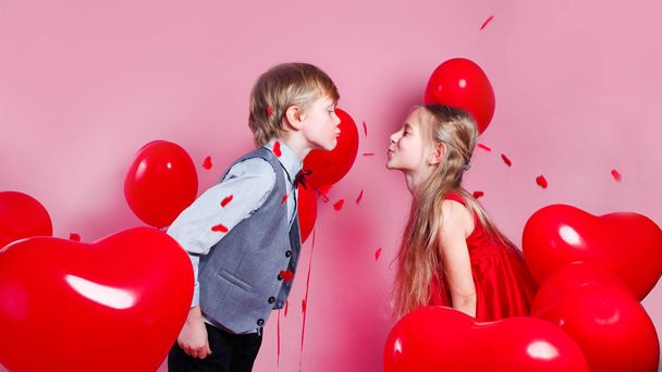 Sweet Valentines day kiss with kids on pink background - Photo, image