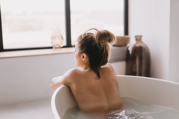 Beautiful woman relaxing in the bathtube. - Fotó, kép