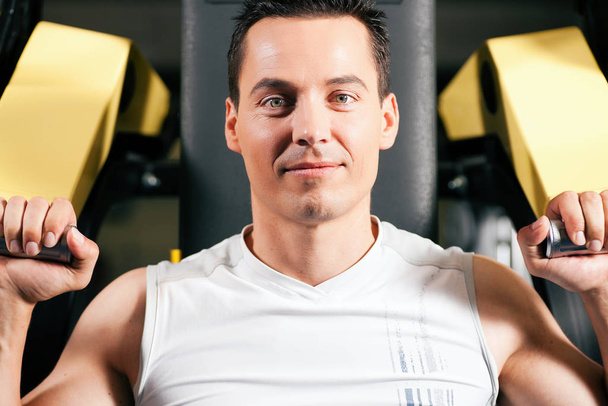 man exercising at the gym equipment - Fotó, kép