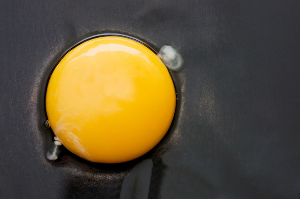 The broken egg on black background - Фото, изображение