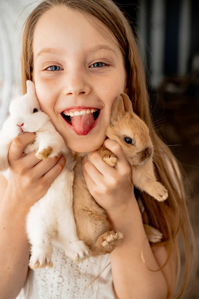 Children play with easter bunnies - Фото, изображение