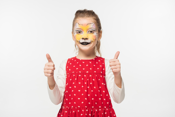 happy child with tiger muzzle painting on face showing thumbs up isolated on white - Photo, Image