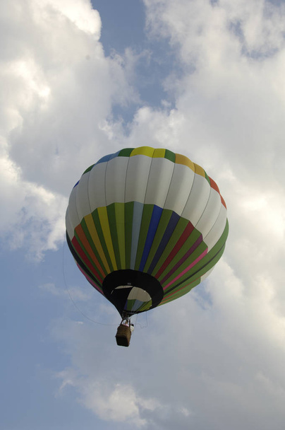 Low angle view of a hot air balloon in the air at the Blossom Time Festival in Chagrin Falls, Ohio. Vertical shot. - Φωτογραφία, εικόνα