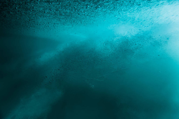 Wave with bubbles underwater. Transparent blue ocean in underwat - Photo, Image