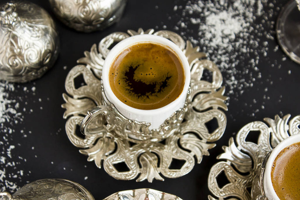 Traditional Turkish sparkling coffee in stylish silver coffee cup on the black surface with coconut powders.Crescent shape in cup.Concept of Feast (Bayram)  - Foto, Bild