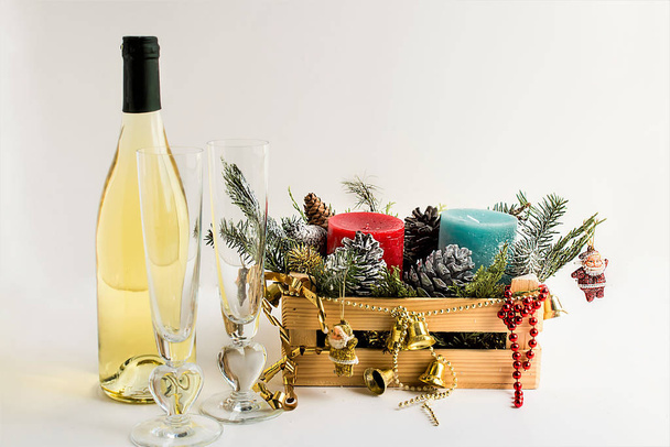 New Year's Eve and celebration concept with two glass of champagne and wooden box full of Christmas decor on white background - Photo, image