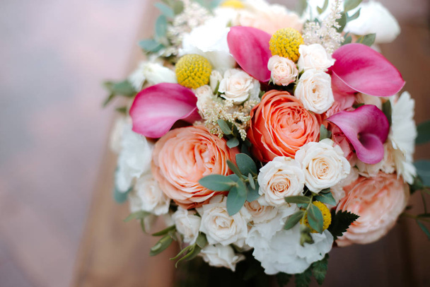 beautiful wedding bouquet with red, pink and white flowers, roses and eucalyptus, peonies, calla lilies - Zdjęcie, obraz