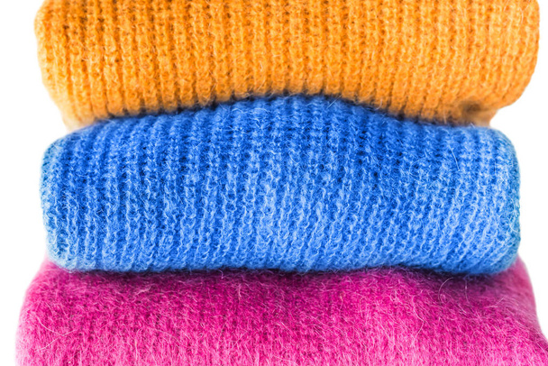 Pile of color woolen sweaters with classic blue one - Photo, Image