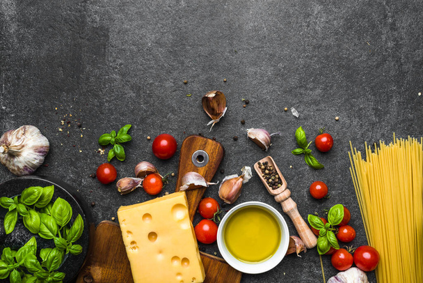 Italian food, cooking ingredients of spaghetti: pasta, tomatoes, basil, garlic, olive oil and cheese - Φωτογραφία, εικόνα