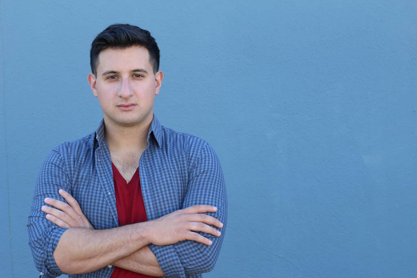 close-up portrait of handsome young man in casual clothes in front of blue wall - Foto, immagini