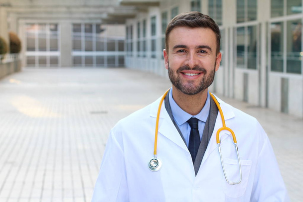close-up portrait of handsome young doctor on street - Photo, Image
