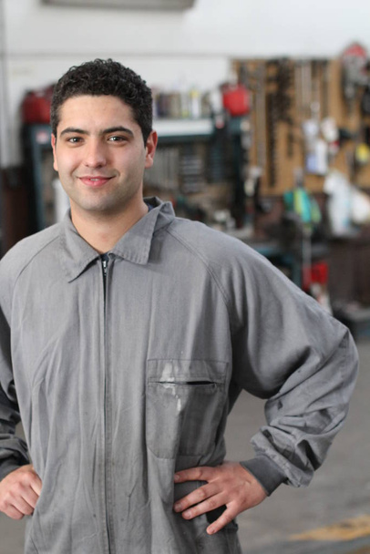 close-up portrait of handsome young man in welder uniform in workshop - Φωτογραφία, εικόνα