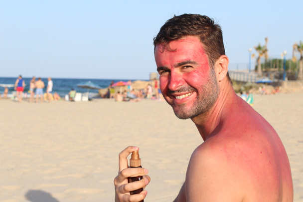 Man getting sunburned at beach - Photo, Image