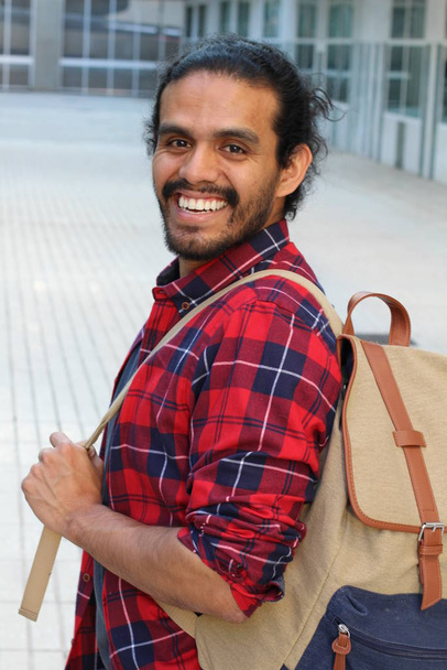 close-up portrait of handsome young man with backpack on street - Photo, Image