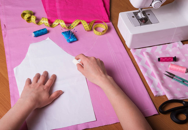 Workshop seamstress. Handmade. Cutting out the fabric pattern - Photo, Image