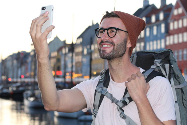 Backpacker smiling during making selfie in epic Nyhavn, Copenhagen, Denmark. - Foto, Imagem