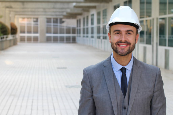 close-up portrait of handsome young businessman in hard hat on street - Foto, afbeelding