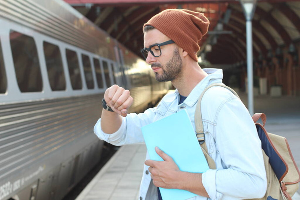Nahaufnahme Porträt eines gutaussehenden jungen Mannes in legerer Kleidung auf dem Bahnhof - Foto, Bild