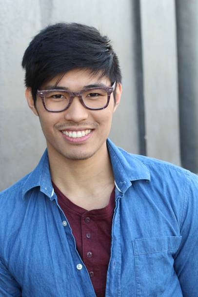close-up portrait of handsome young asian man in front of grey wall - Photo, Image