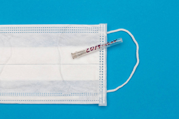 New coronavirus, needle test tube with the inscription 2019-nCoV with respiratory mask - Photo, Image