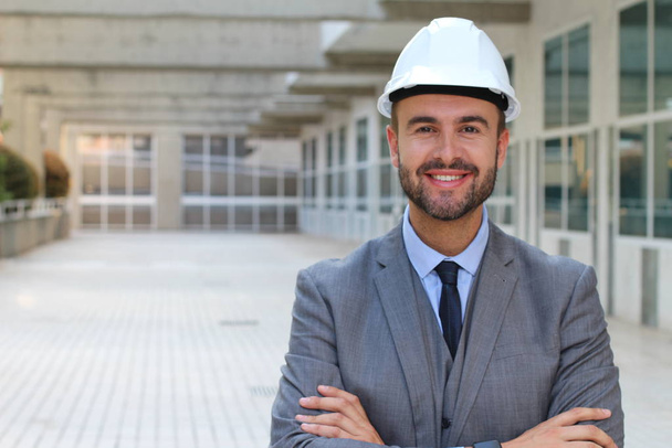 close-up portrait of handsome young businessman in hard hat on street - Photo, Image