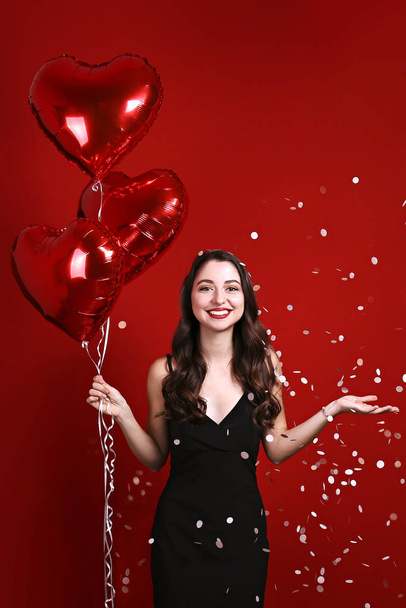 Beautiful female holding floating balloons for st. valentine's day holiday. - Foto, Imagen