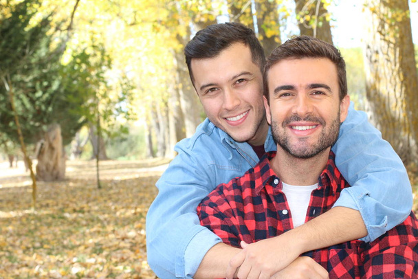 Gay couple enjoying the park in autumn - Photo, Image
