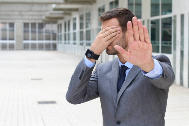 Denial concept with businessman covering his eyes - Foto, Imagen