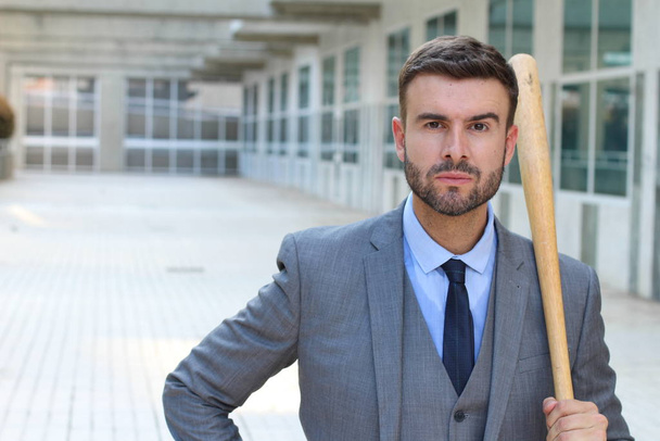 close-up portrait of handsome young businessman with baseball bat on street - Foto, Imagen