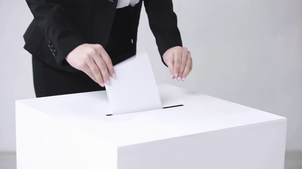 cropped view of woman voting on white - Materiał filmowy, wideo