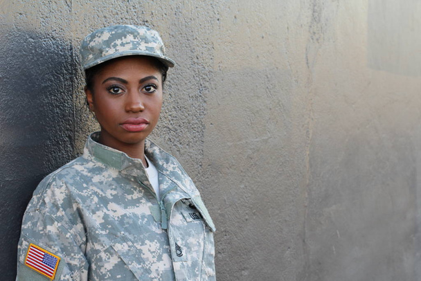 Female American Soldier on grey wall background  - Photo, Image