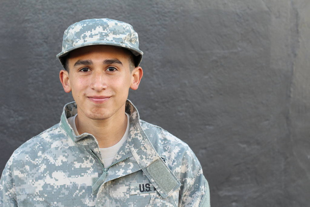 close-up portrait of handsome young soldier in front of grey concrete wall - Foto, Bild