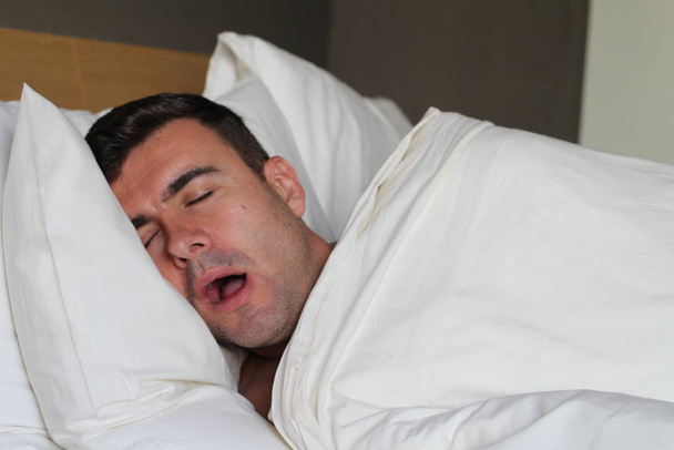 Ethnic man deeply slept in comfy bed - Foto, Imagem