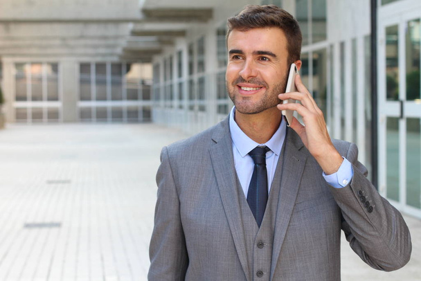 Businessman listening on the phone with enthusiasm - Photo, Image