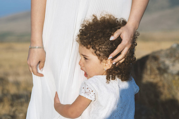 little beautiful girl cries and hugs mother outdoor - Valokuva, kuva