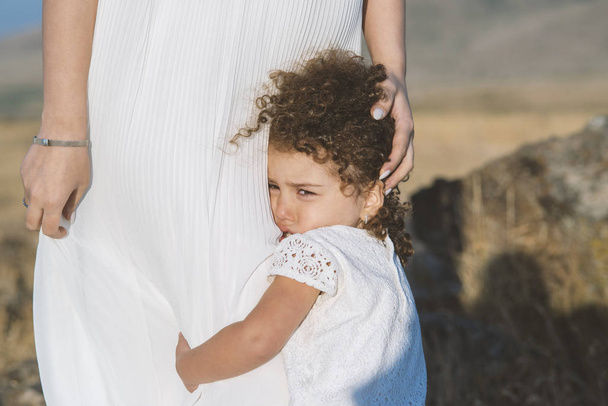 little beautiful girl cries and hugs mother outdoor - Fotografie, Obrázek
