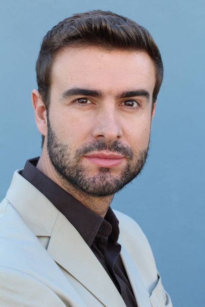 close-up portrait of handsome young bearded man in front of wall - Photo, Image